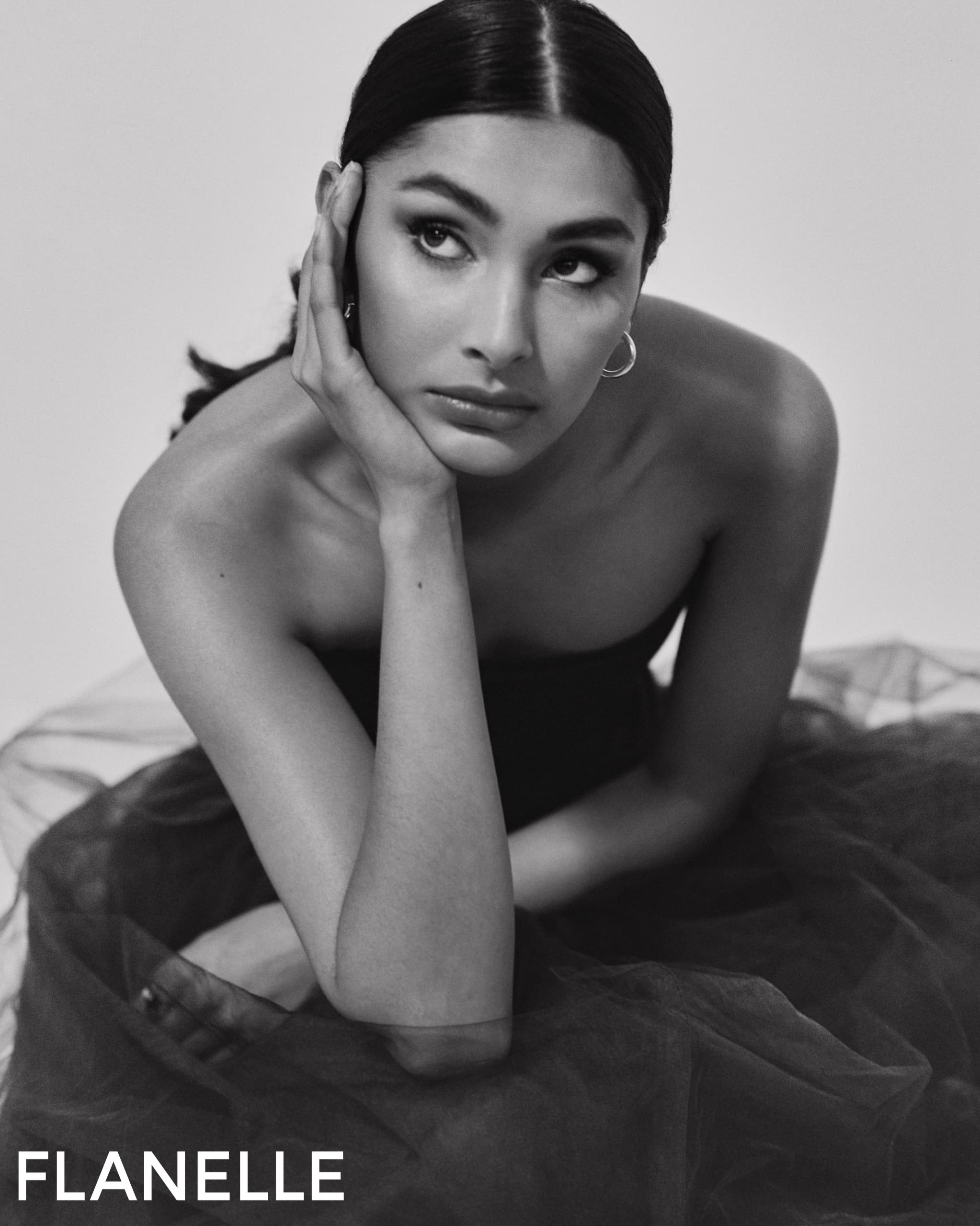 Black and white portrait of woman in elegant pose for Flanelle magazine.