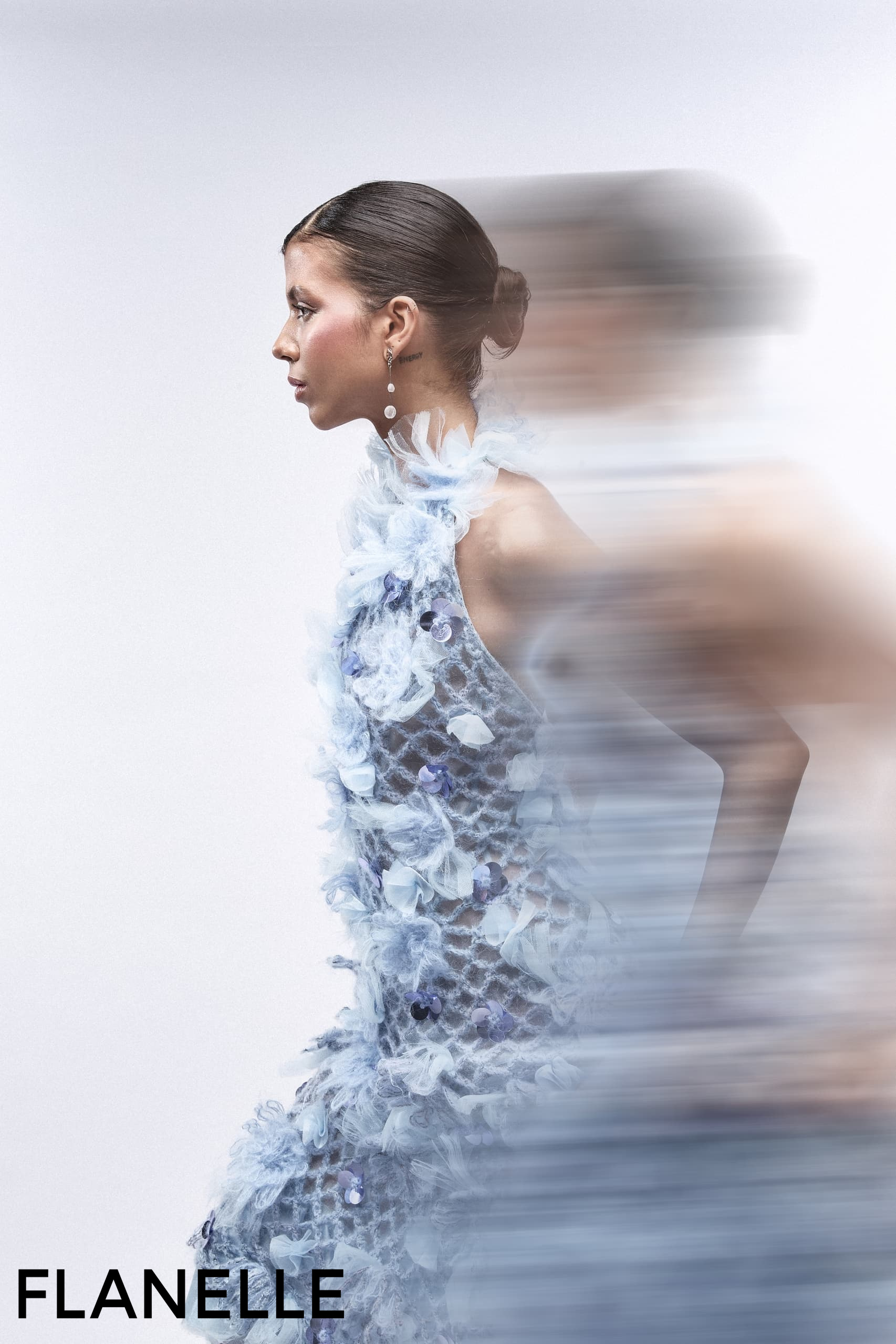 Woman in elegant blue dress with motion blur effect.