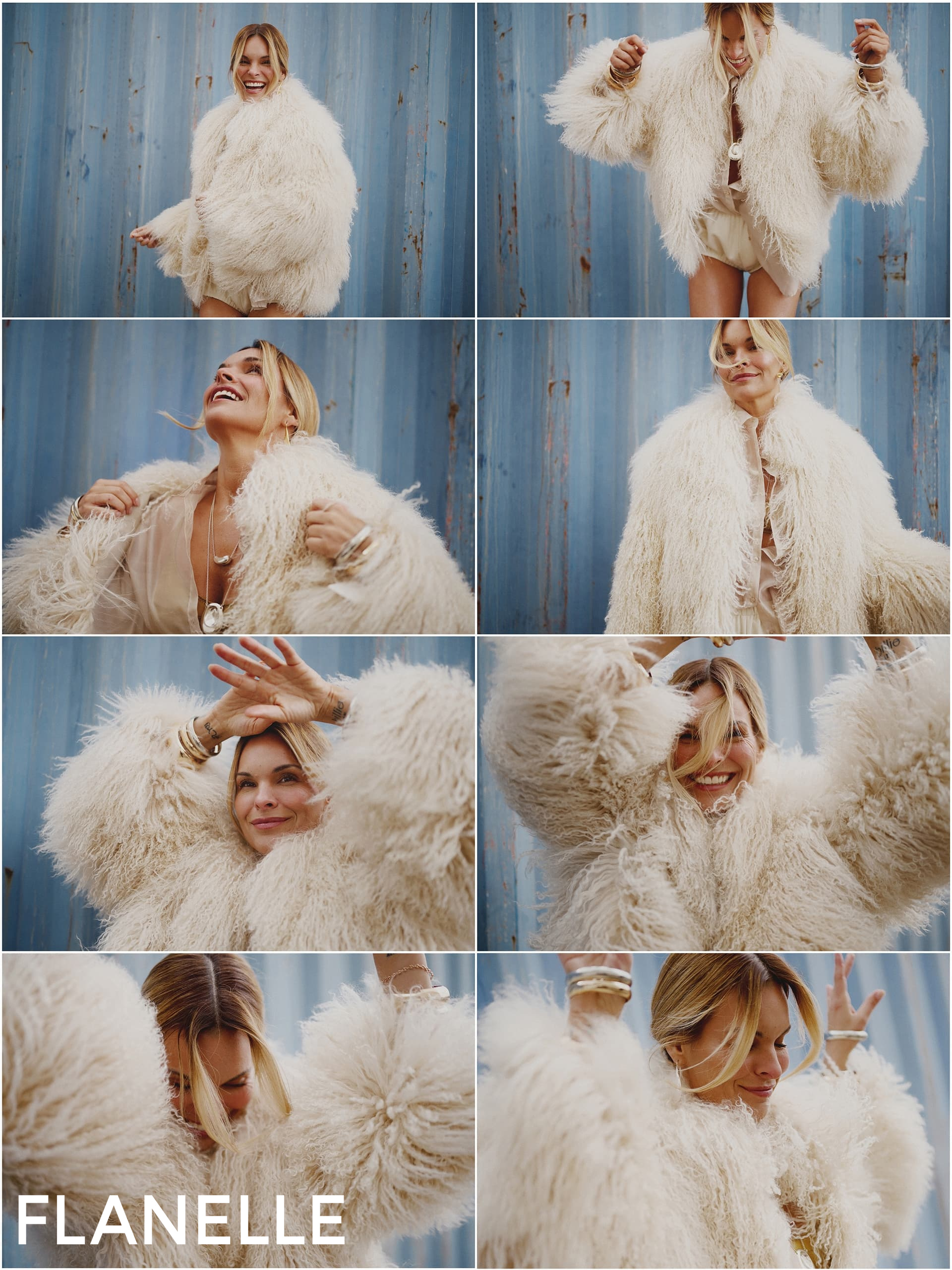 Woman in fluffy coat posing joyfully against a blue backdrop.