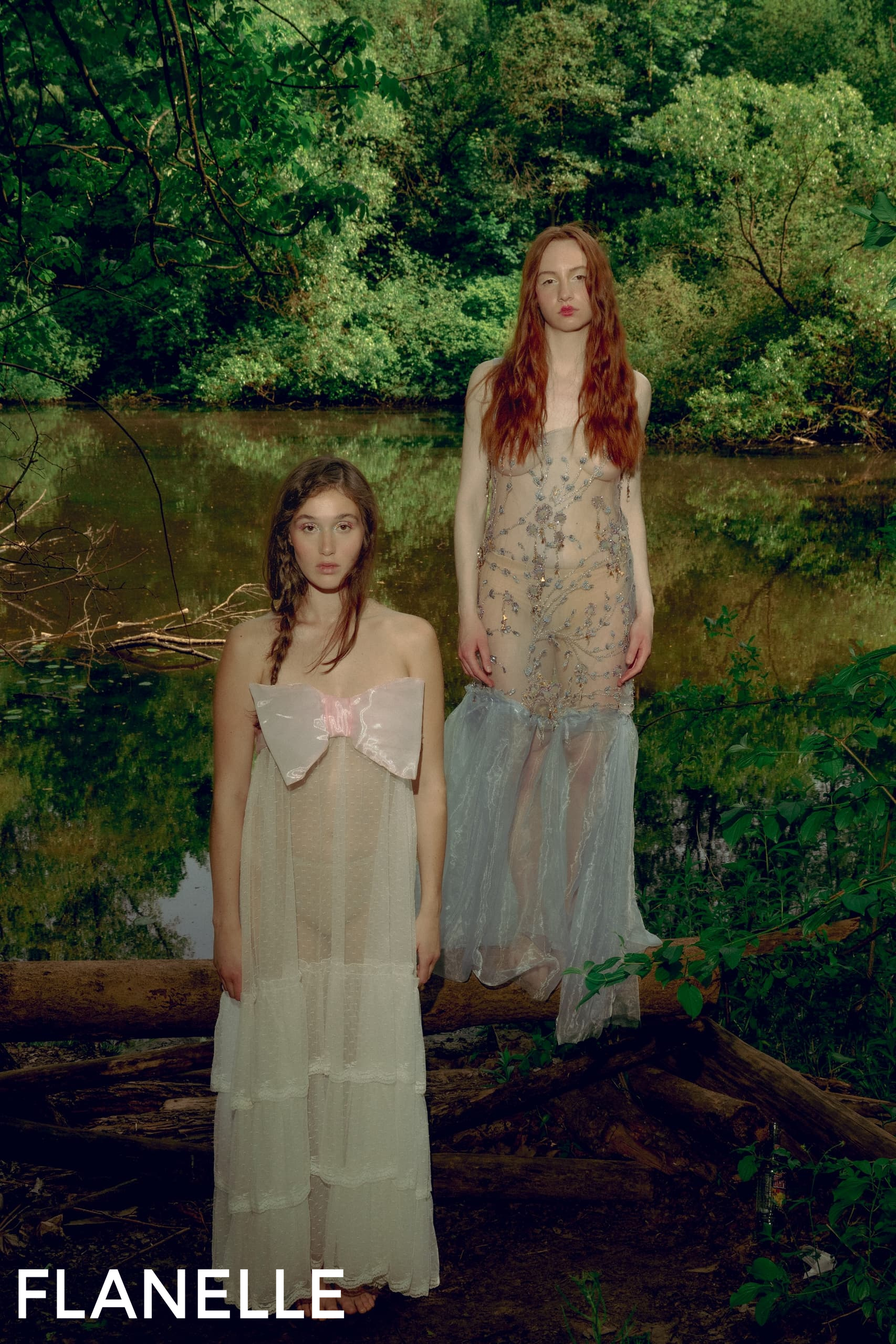 Models in ethereal dresses by the river, surrounded by lush greenery. Flanelle branding.