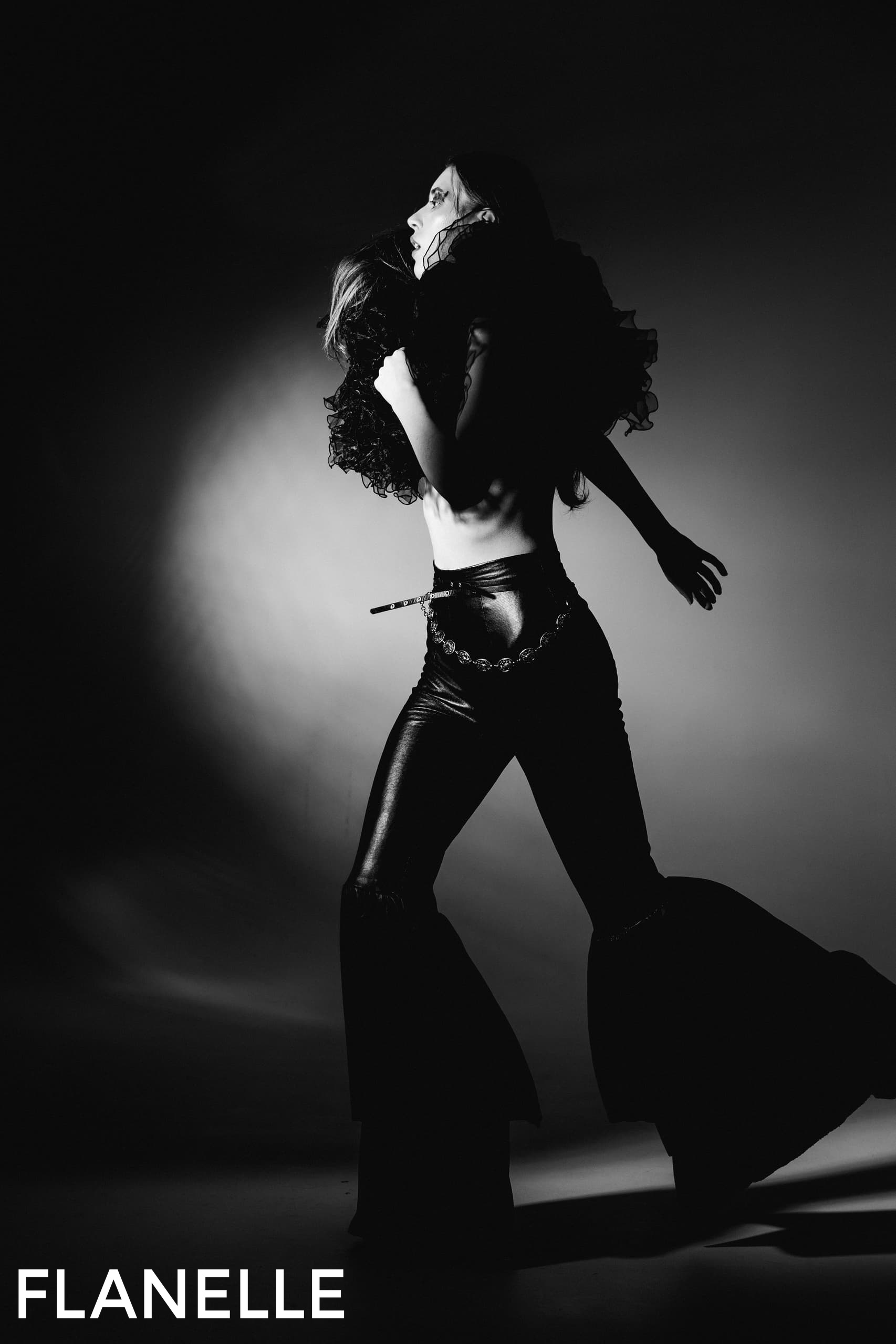 Fashionable silhouette in dramatic black and white, showcasing flair and style.