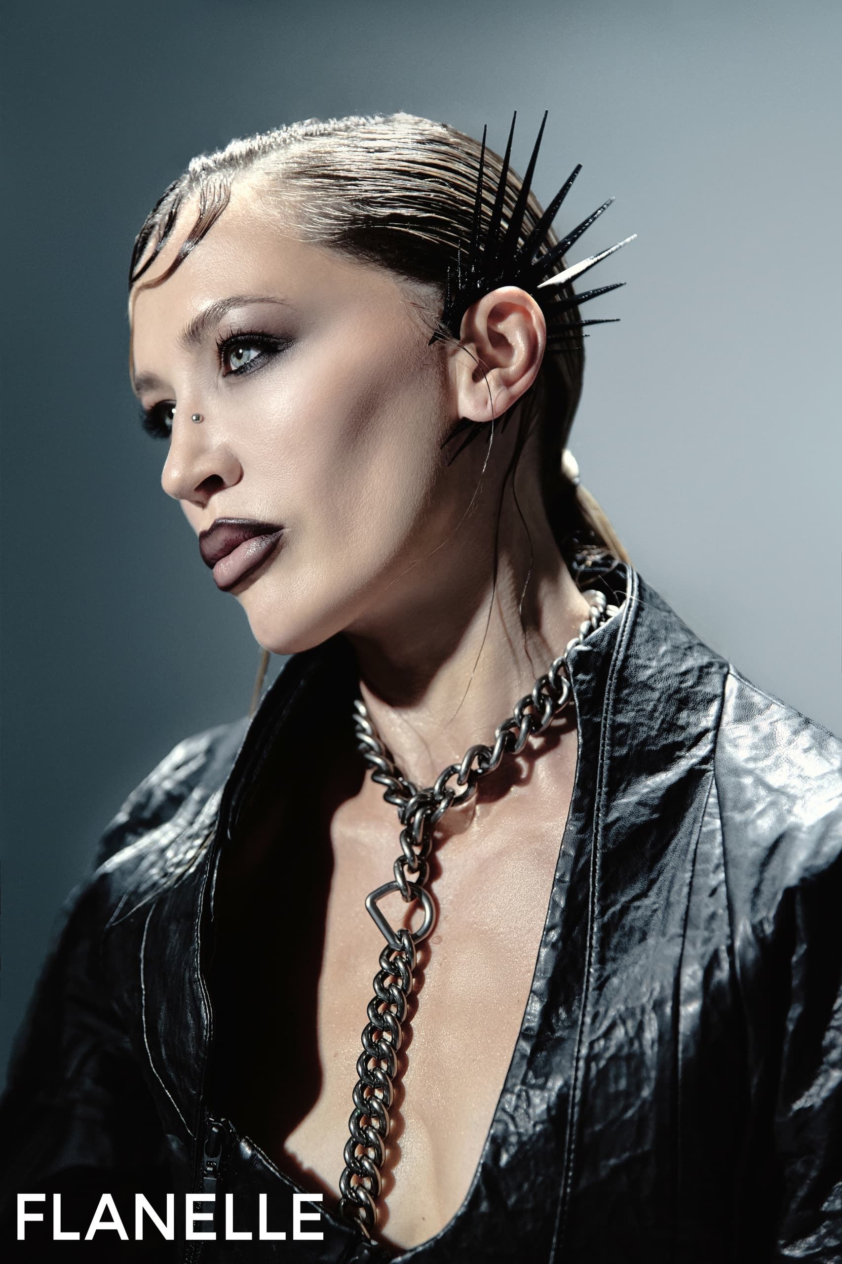Edgy fashion portrait with spiked accessories and bold makeup. Flanelle magazine.