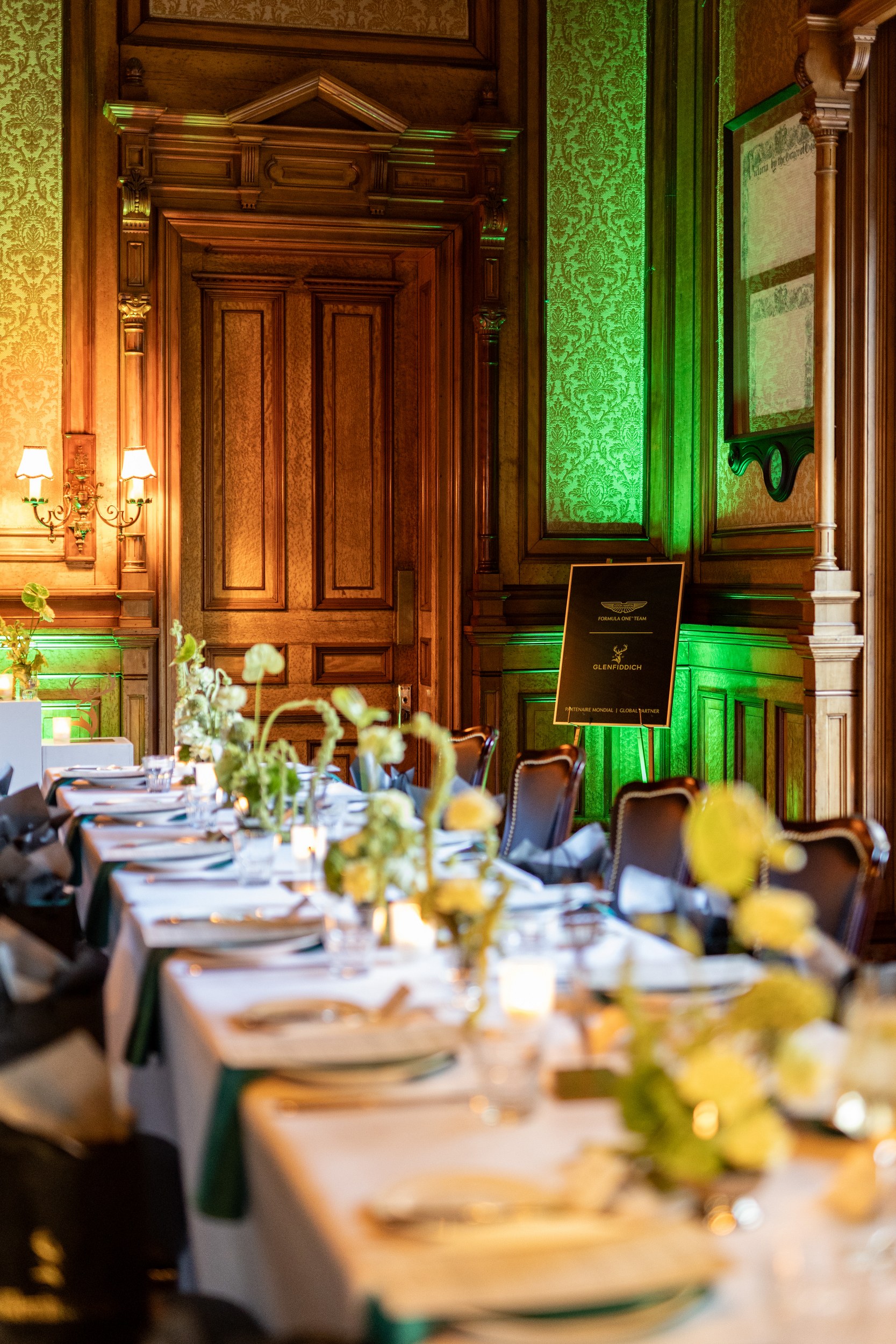 Elegant dining room setup with floral decor and luxurious wooden interior.