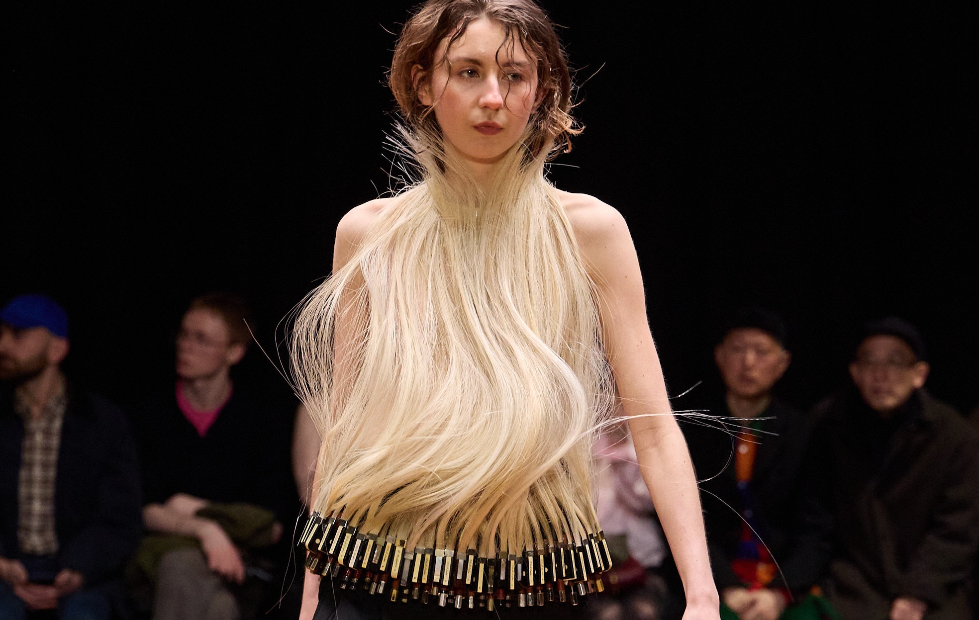 Model in a unique flowing hair dress on the runway.