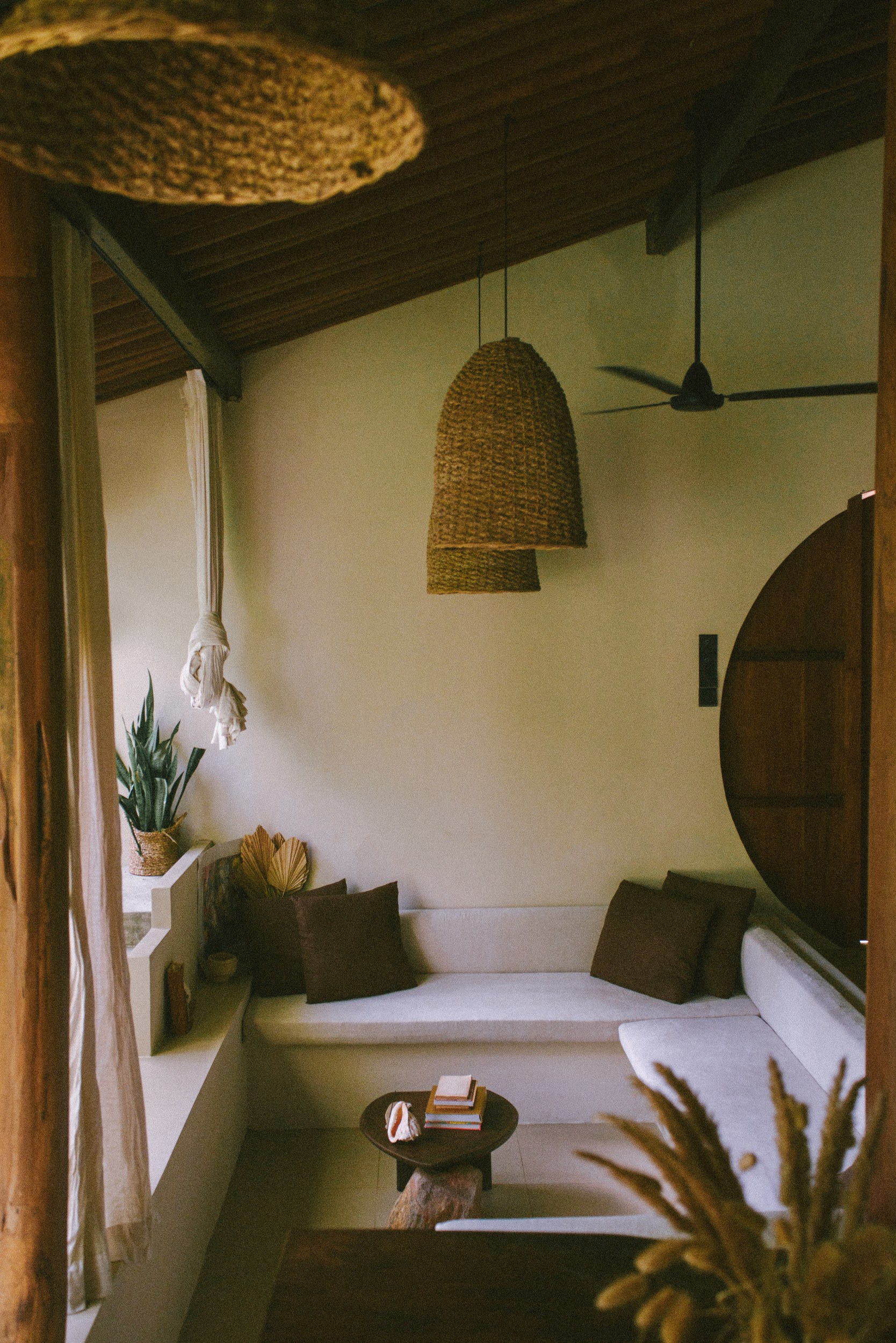 Cozy rustic room with woven lamps, seating, and decor accents.