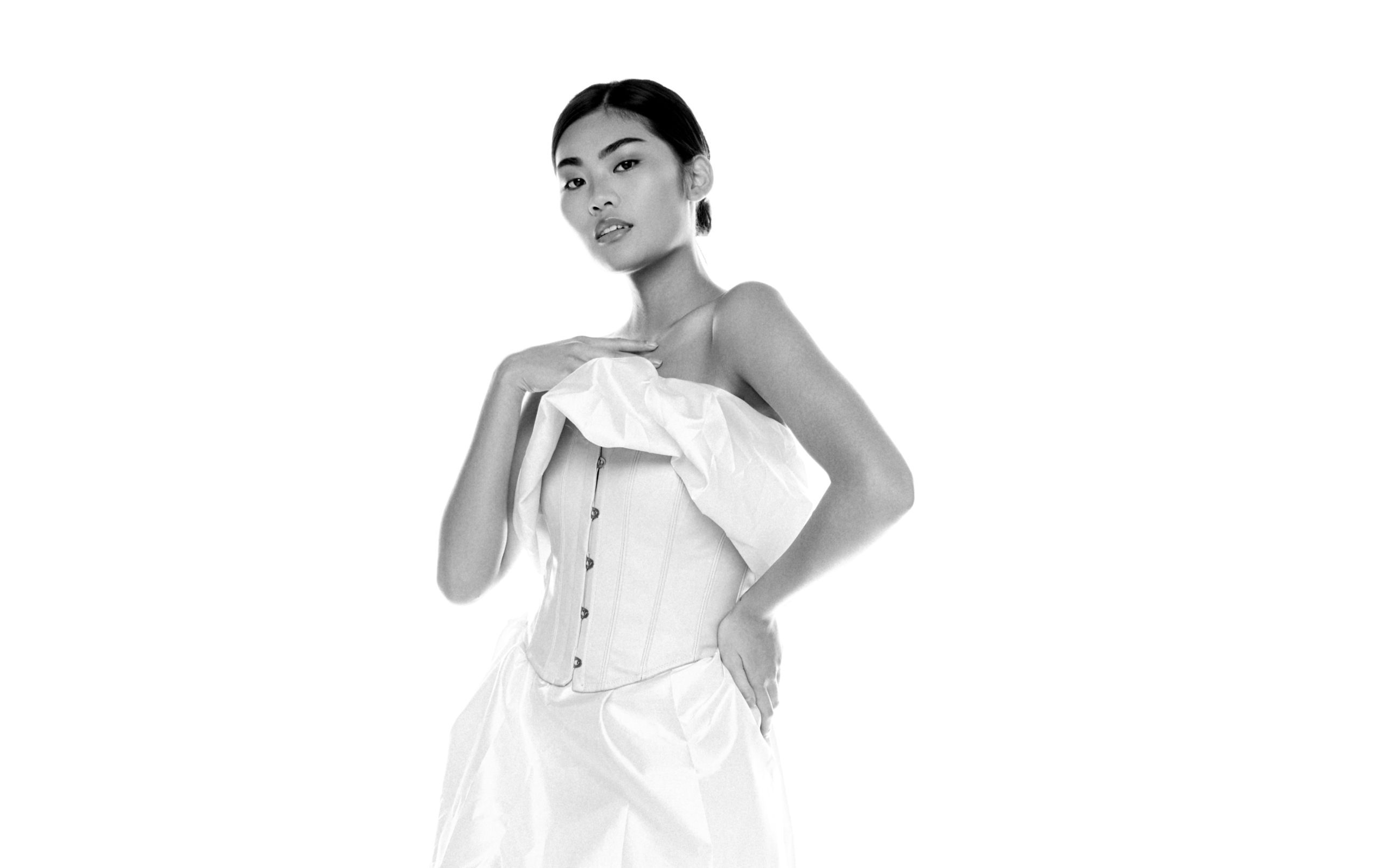 Elegant woman in strapless dress, black and white portrait.