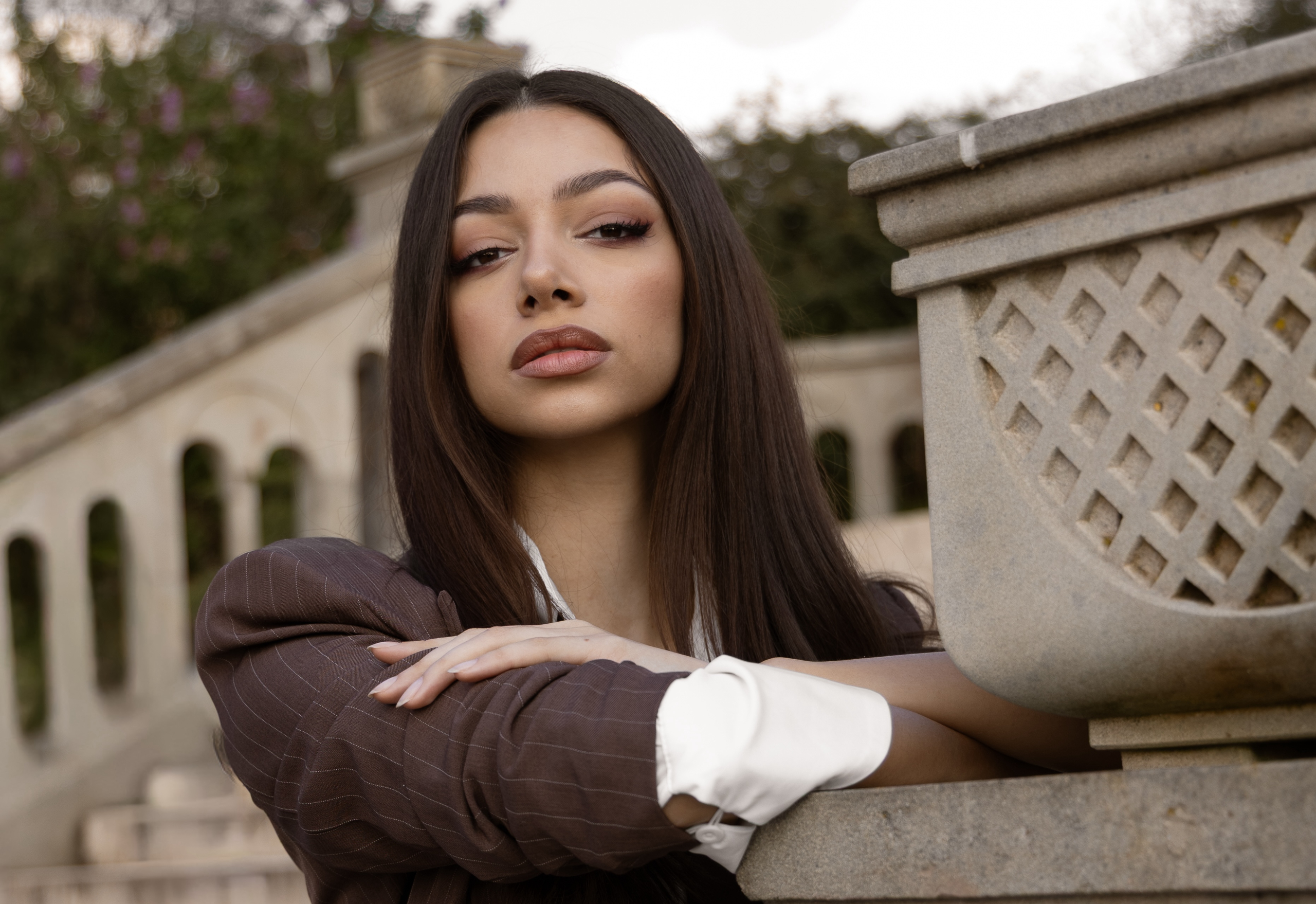 Confident woman with long hair in elegant setting.