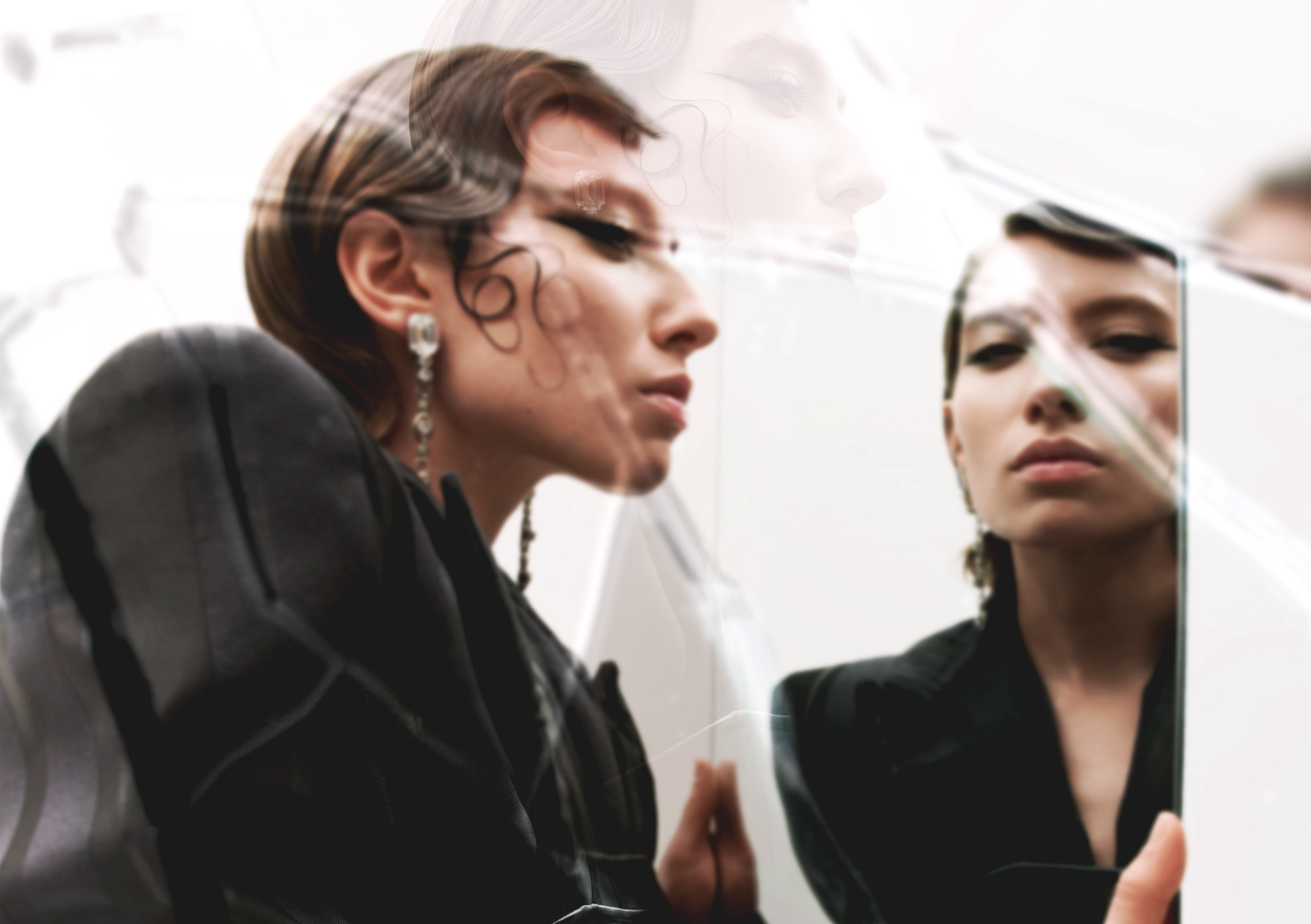 Woman with artistic makeup gazing at her reflection in a mirror.