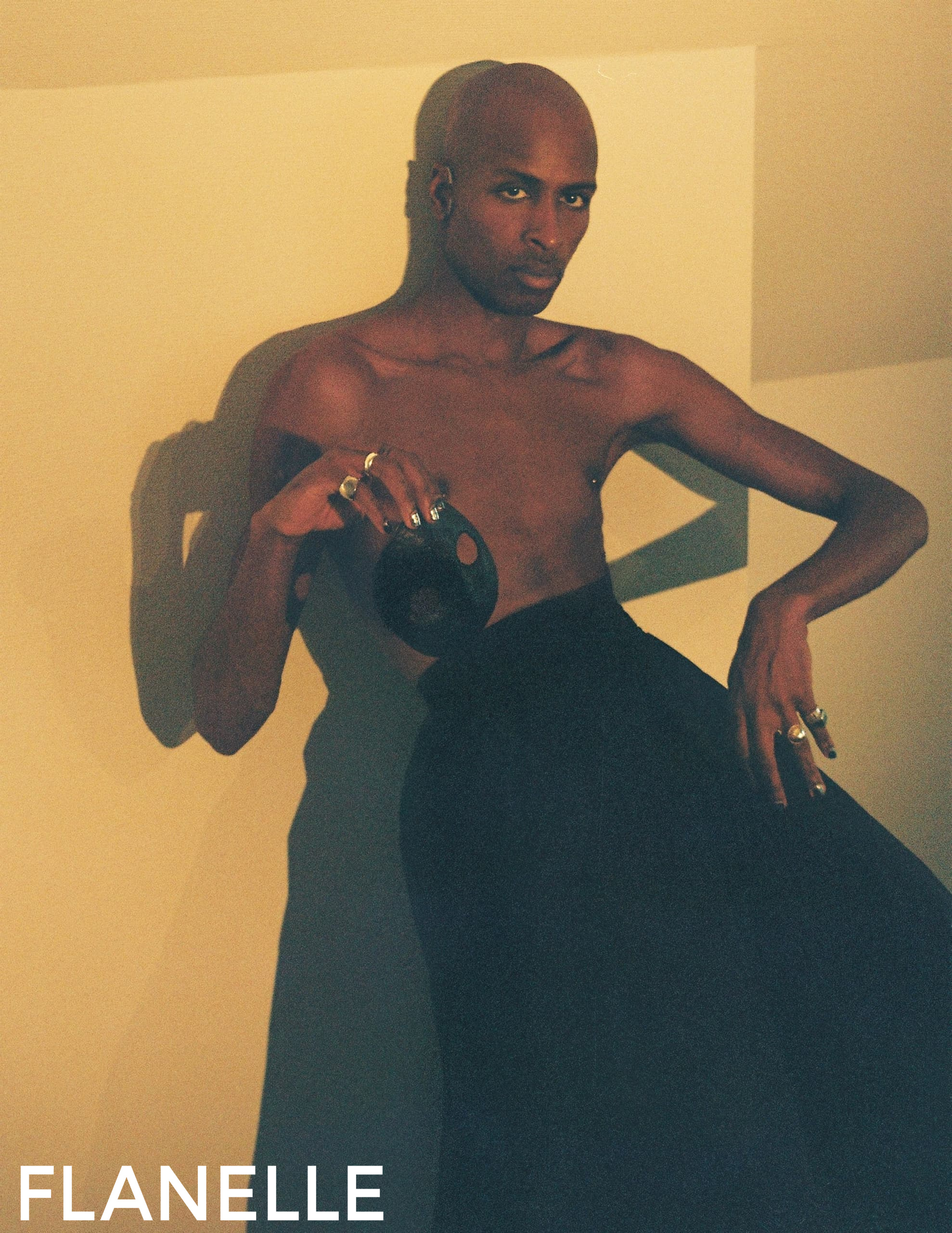 Elegant fashion pose with rings in soft lighting for Flanelle Magazine.