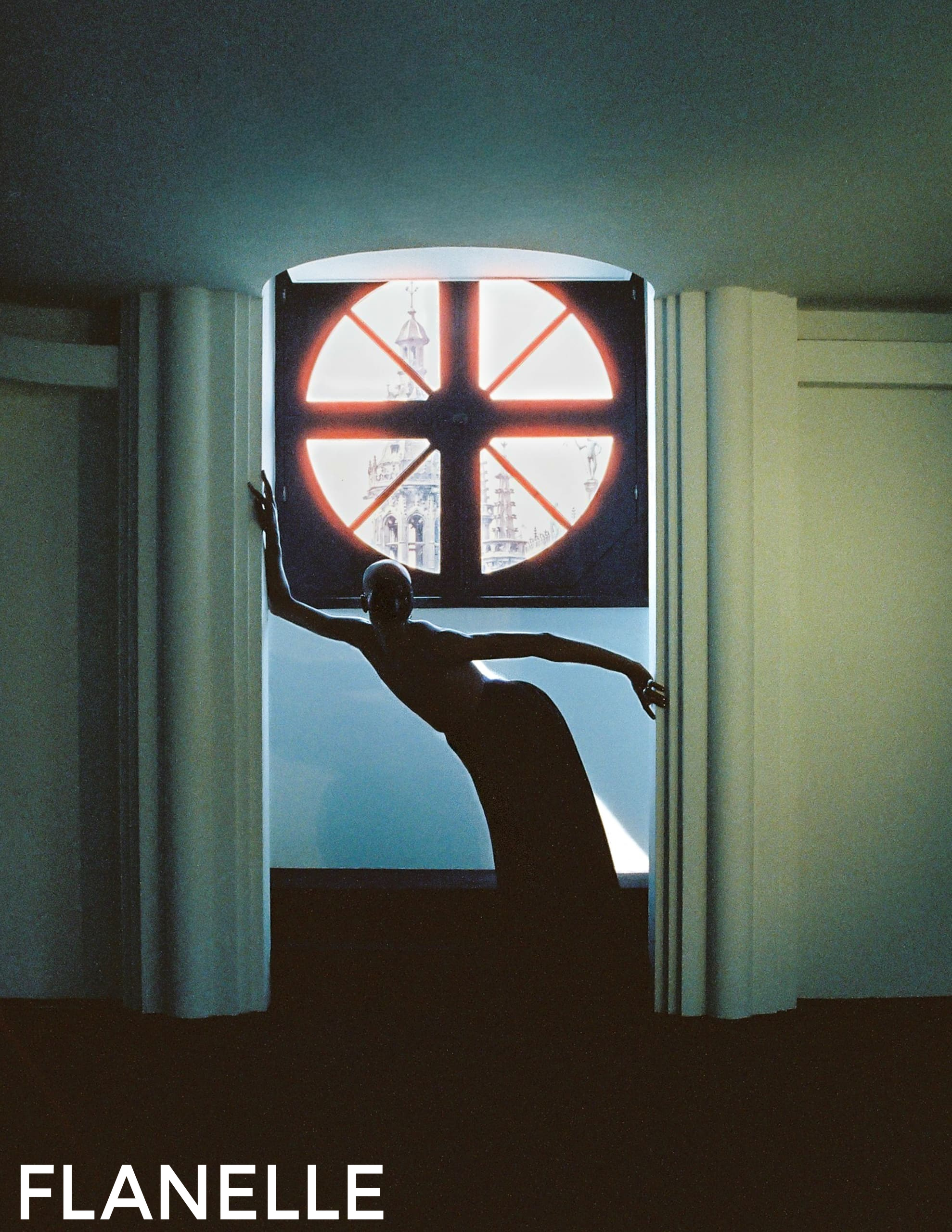Silhouette of a person posing in front of a circular window with city view.