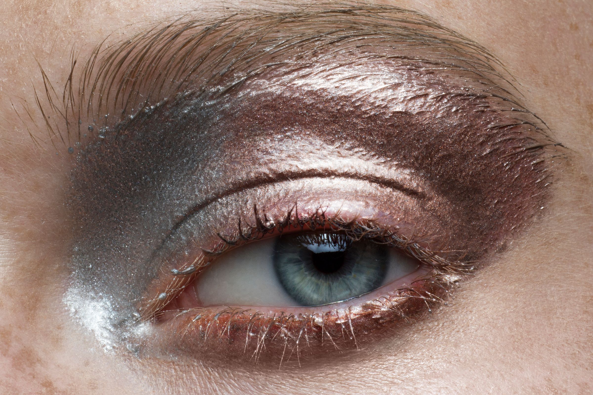 Close-up of eye with dramatic metallic eyeshadow makeup.
