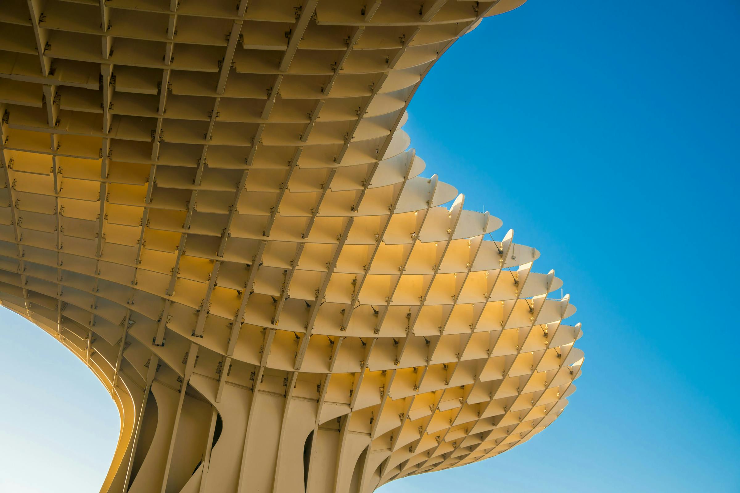 Modern architectural structure against a clear blue sky.